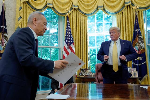 FILE PHOTO: China's Vice Premier Liu He hands a letter from China's President Xi Jinping to U.S. President Donald Trump during their meeting in the Oval Office of the White House in Washington, U.S., October 11, 2019. REUTERS/Yuri Gripas/File Photo