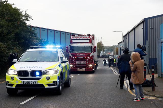 FILE PHOTO: Police move the lorry container where bodies were discovered, in Grays, Essex, Britain October 23, 2019.  REUTERS/Hannah McKay/File Photo