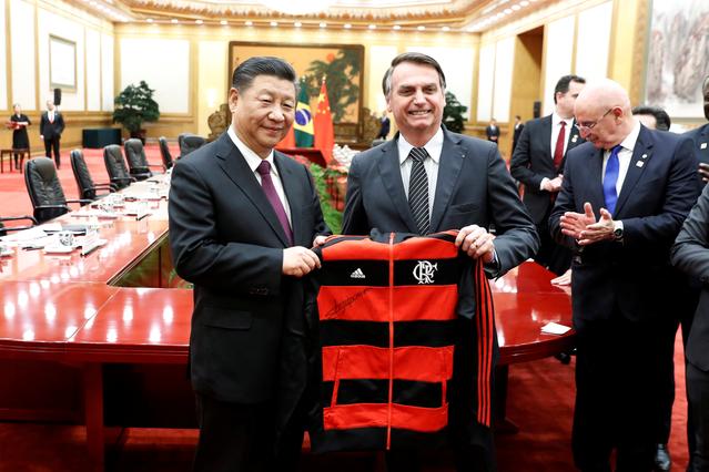 FILE PHOTO: China's President Xi Jinping revives a gift from Brazil's President Jair Bolsonaro at the end of the signing ceremony at the Great Hall of the People in Beijing, China October 25, 2019. Yukie Nishizawa/Pool via REUTERS/File Photo