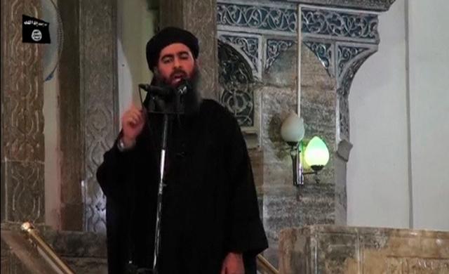 FILE PHOTO: A man purported to be the reclusive leader of the militant Islamic State Abu Bakr al-Baghdadi has made what would be his first public appearance at a mosque in the centre of Iraq's second city, Mosul, according to a video recording posted on the Internet on July 5, 2014, in this still image taken from video.   Social Media Website via Reuters TV/File Photo   