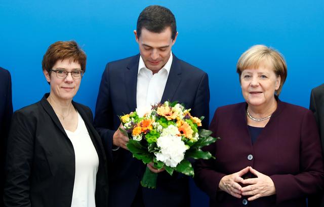 Germany's Christian Democratic Union (CDU) leader and Defence Minister Annegret Kramp-Karrenbauer and German Chancellor Angela Merkel congratulate their conservative party's top candidate in the Thuringia state elections Mike Mohring at a roundtable meeting in Berlin, Germany October 28, 2019. REUTERS/Michele Tantussi
