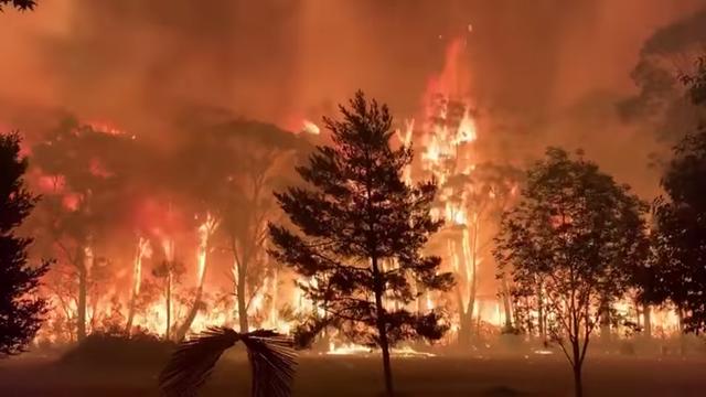 FILE PHOTO: A fire blazes across bush as seen from Mount Tomah in New South Wales, Australia December 15, 2019 in this still image obtained from social media video. NSW RFS – TERRY HILLS BRIGADE/via REUTERS 