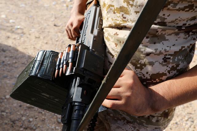 FILE PHOTO: A member of Libya's internationally recognised government forces carries a weapon in Ain Zara, Tripoli, Libya October 14, 2019.  REUTERS/Ismail Zitouny/File Photo