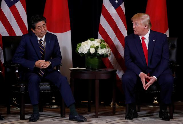 FILE PHOTO: Japan's Prime Minister Shinzo Abe listens to U.S. President Donald Trump during a bilateral meeting on the sidelines of the 74th session of the United Nations General Assembly (UNGA) in New York City, New York, U.S., September 25, 2019.  REUTERS/Jonathan Ernst
