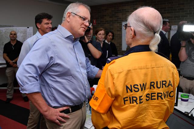 FILE PHOTO: Australia's Prime Minister Scott Morrison greets a volunteer during a visit to the Wollondilly Emergency Control Centre in Sydney, Australia, December 22, 2019. AAP Image/Joel Carrett/via REUTERS