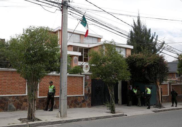 Police officers stand guard next to Mexico's embassy in La Paz, Bolivia December 26, 2019. REUTERS/David Mercado
