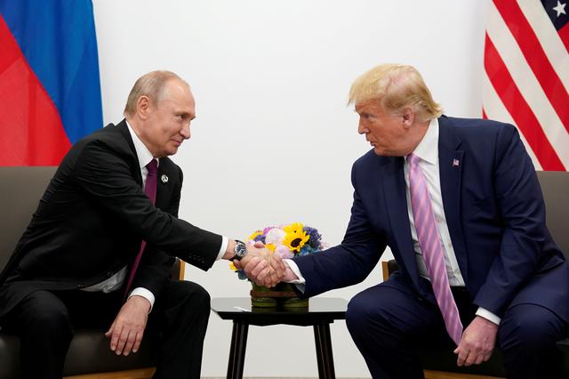 FILE PHOTO: Russia's President Vladimir Putin and U.S. President Donald Trump shake hands during a bilateral meeting at the G20 leaders summit in Osaka, Japan, June 28, 2019.  REUTERS/Kevin Lamarque/File Photo