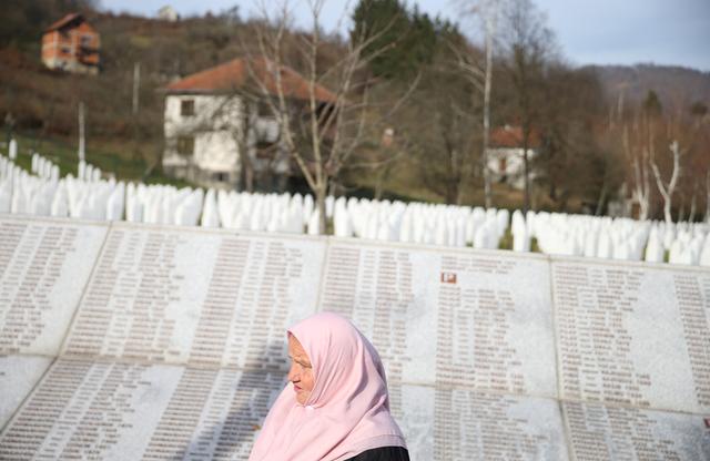 FILE PHOTO: A woman walks past the Memorial plaque with the names of people killed in the Srebrenica massacre at the Memorial centre Potocari near Srebrenica, Bosnia and Herzegovina, November 22, 2017. REUTERS/Dado Ruvic/File Photo