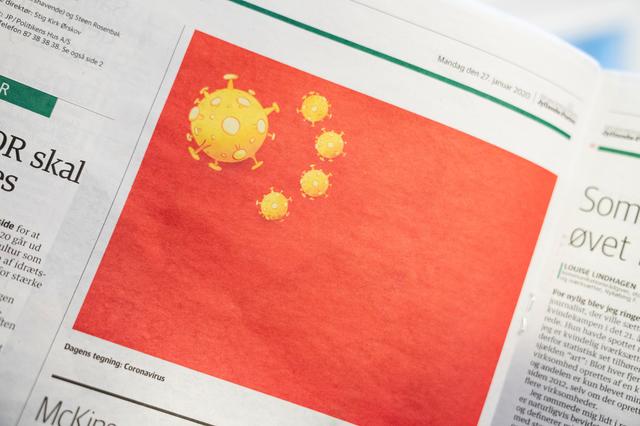 A cartoon of the coronavirus depicted as part of the Chinese national flag, is pictured in the Danish newspaper Jyllands-Posten's Monday January 27, 2020 edition, in Copenhagen, Denmark. Ritzau Scanpix/Ida Marie Odgaard via REUTERS 
