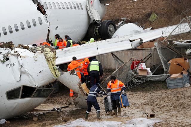 People work at the Pegasus Airlines Boeing 737-86J plane wreckage, after it overran the runway during landing and crashed, at Istanbul's Sabiha Gokcen airport, Turkey February 6, 2020. REUTERS/Murad Sezer