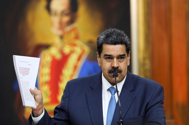 Venezuela's President Nicolas Maduro holds a document as he speaks during a news conference at Miraflores Palace in Caracas, Venezuela February 14, 2020. REUTERS/Fausto Torrealba 