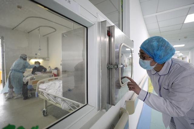 A medical worker calls his colleague inside an isolated ward at Jinyintan Hospital in Wuhan, the epicentre of the novel coronavirus outbreak, in Hubei province, China February 13, 2020. Picture taken February 13, 2020. China Daily via REUTERS  