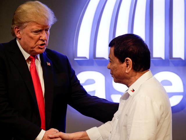 FILE PHOTO: U.S. President Donald J. Trump (L) shakes hands with Philippine President Rodrigo Duterte (R) before the opening ceremony of the 31st Association of Southeast Asian Nations (ASEAN) Summit in Manila, Philippines,13 November 2017. REUTERS/Mark R. Cristino/Pool