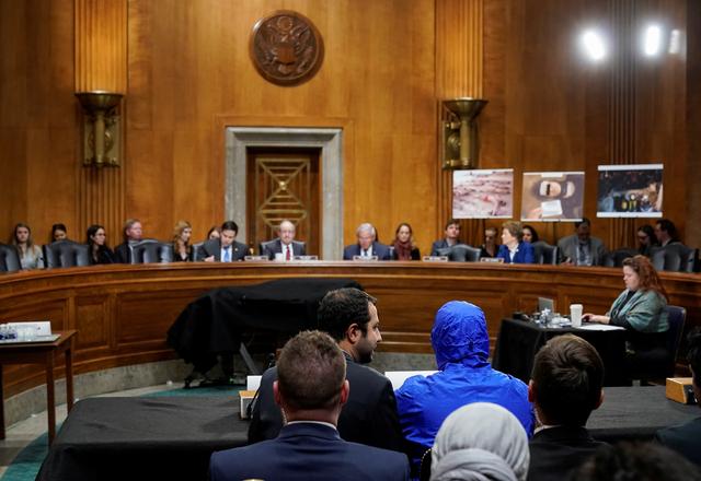 A Syrian military defector using the pseudonym 'Caesar' wears a hood as he testifies before the Senate Foreign Relations Committee during a hearing titled, Nine Years of Brutality: Assad's Campaign Against the Syrian People on Capitol Hill in Washington, U.S., March 11, 2020.      REUTERS/Joshua Roberts