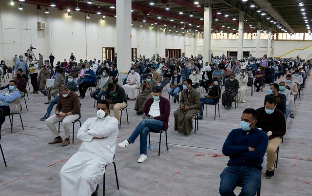 FILE PHOTO: Expatriates wait for mandatory coronavirus testing in a makeshift testing centre in Mishref, Kuwait  March 14, 2020. REUTERS/Stephanie McGehee