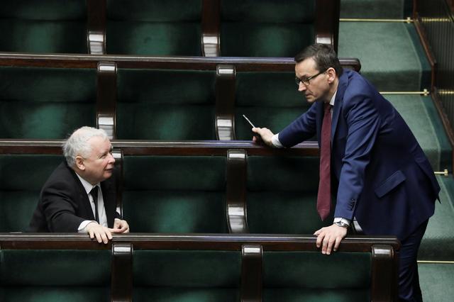 Law and Justice (PiS) leader Jaroslaw Kaczynski and Polish Prime Minister Mateusz Morawiecki attends a parliament sitting following the outbreak of coronavirus disease (COVID-19) at parlaiment in Warsaw, Poland, March 27, 2020.  Poland's parliament passed a law early on Saturday allowing postal voting for senior citizens and those in quarantine or self-isolating as the government looks to press ahead with May presidential elections which opposition parties want postponed. Slawomir Kamisnki/Agencja Gazeta via REUTERS