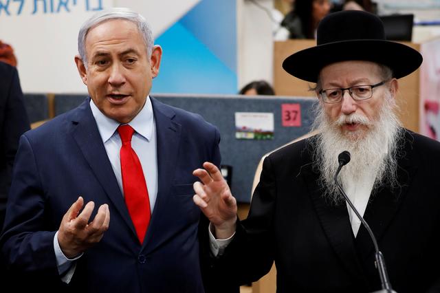 FILE PHOTO: Israeli Prime Minister Benjamin Netanyahu and Health Minister Yaakov Litzman gesture as they deliver statements during a visit to the Health Ministry national hotline, in Kiryat Malachi, Israel March 1, 2020. REUTERS/Amir Cohen/File Photo