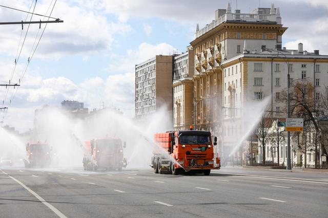Vehicles drive near the U.S. embassy and spray disinfectant while sanitizing a road to prevent the spread of the coronavirus disease (COVID-19) in Moscow, Russia April 12, 2020. Andrey Nikerichev/Moscow News Agency/Handout via REUTERS 