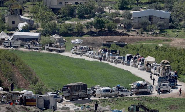 Vehicles carrying belongings of internally displaced Syrians drive back to their homes, as some people are afraid of the coronavirus disease (COVID-19) outbreak in crowded camps, in Dayr Ballut, Syria April 11, 2020.  REUTERS/Khalil Ashawi    