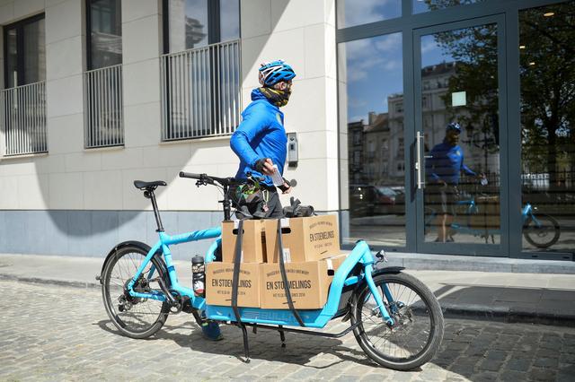 An employee of the Dioxyde de Gambettes, cooperative company with a social purpose, delivers Belgian Beer from the Enstoemelings factory, as the Belgian brewer tries to keep business up by offering a home delivery service for his customers, in Brussel, Belgium, April 14, 2020. Reuters/ Johanna Geron