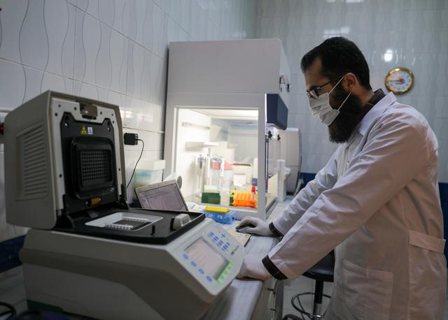 Mohamad Shahim Makki, a doctor, wears protective gear as he works at a laboratory that deals with coronavirus disease (COVID-19) testing in Idlib, Syria April 13, 2020. REUTERS/Khalil Ashawi