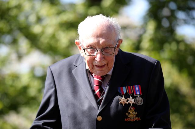FILE PHOTO: Retired British Army Captain Tom Moore, 99, raises money for health workers by attempting to walk the length of his garden one hundred times before his 100th birthday this month as the spread of coronavirus disease (COVID-19) continues, Marston Moretaine, Britain, April 15, 2020. REUTERS/Peter Cziborra/File Photo