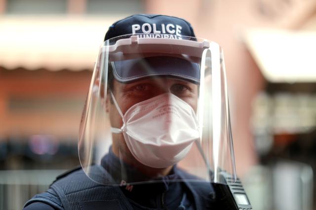 A municipal police officer wearing protective face mask stands guard at  Forville market,  as a lockdown is imposed to slow the rate of the coronavirus disease (COVID-19), in Cannes, France, April 25, 2020.    REUTERS/Eric Gaillard