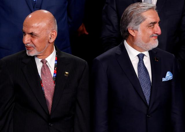 FILE PHOTO: Afghanistan's President Ashraf Ghani (L) and Afghanistan's Chief Executive Abdullah Abdullah (R) participate in a family photo at the NATO Summit in Warsaw, Poland July 8, 2016. REUTERS/Jonathan Ernst/File Photo