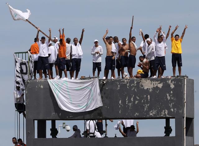 Inmates at Puraquequara's prison are seen on the roof during a riot following an outbreak of the coronavirus disease (COVID-19), in Manuas, Brazil, May 2, 2020. REUTERS/Bruno Kelly