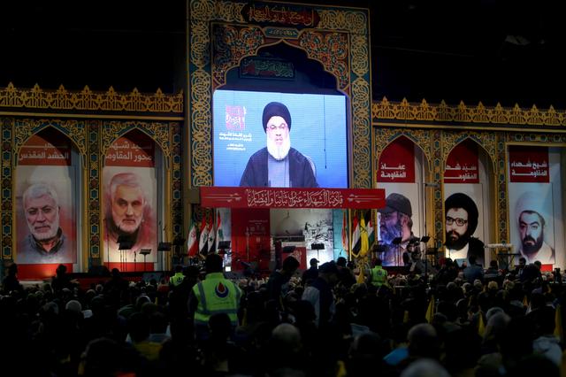 FILE PHOTO: Lebanon's Hezbollah leader Sayyed Hassan Nasrallah addresses his supporters through a screen during a rally commemorating the annual Hezbollah's slain leaders in Beirut's southern suburbs, Lebanon February 16, 2020. REUTERS/Aziz Taher