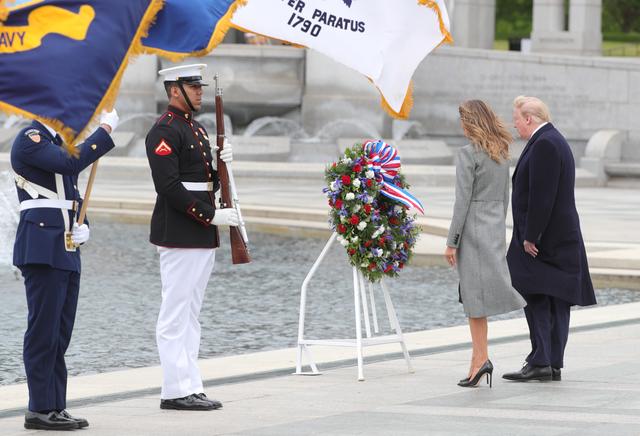 U.S. President Donald Trump and first lady Melania Trump stand in front of a wreath during a Victory in Europe Day 75th anniversary ceremony at the World War II Memorial in Washington, U.S., May 8, 2020. REUTERS/Tom Brenner