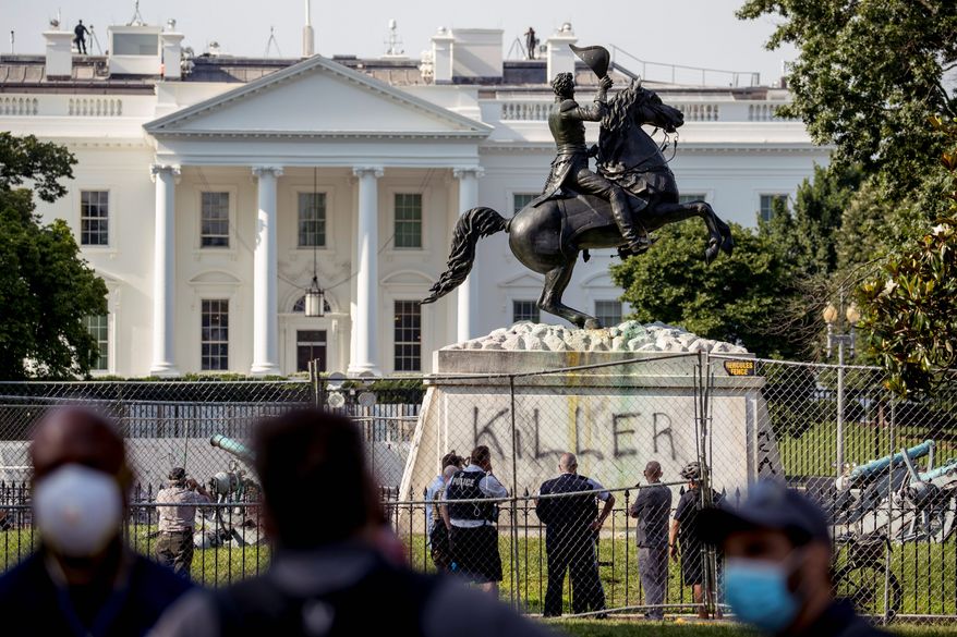 Four men have been charged with damaging and trying to tear down the Andrew Jackson statue in Lafayette Park, which is adjacent to the White House. Prosecutors said all four men were caught on video using straps to try to pull down the statue. (Associated Press) ** FILE **