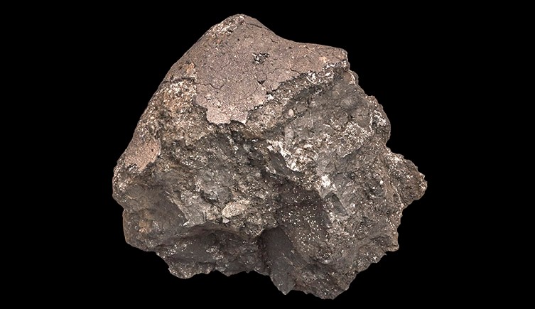 A picture of the Ivuna meteroite, showing its metallic, almost coppery colour.  