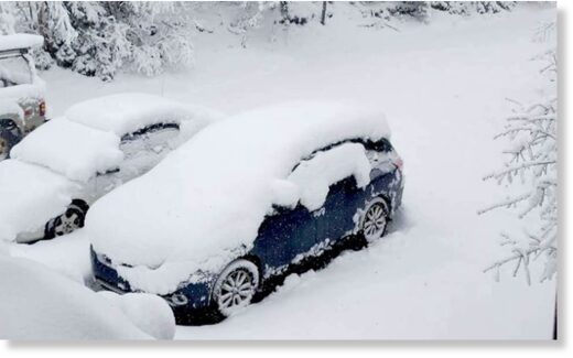 Vehicles buried in more than foot of snow in Ishpeming, Michigan on May 1, 2023.